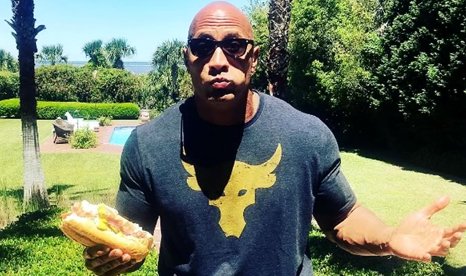 The Rock eating a sandwich like a normal person.